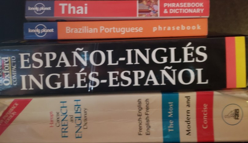 Various language dictionaries and phrasebooks: French, English, Brazilian Portuguese, Thai