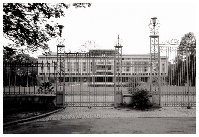 Large government building behind a tall metal fence