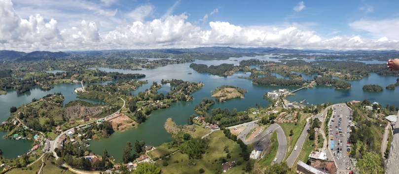 Large, irregularly shaped reservoir dotted with islands under a partly clouded sky