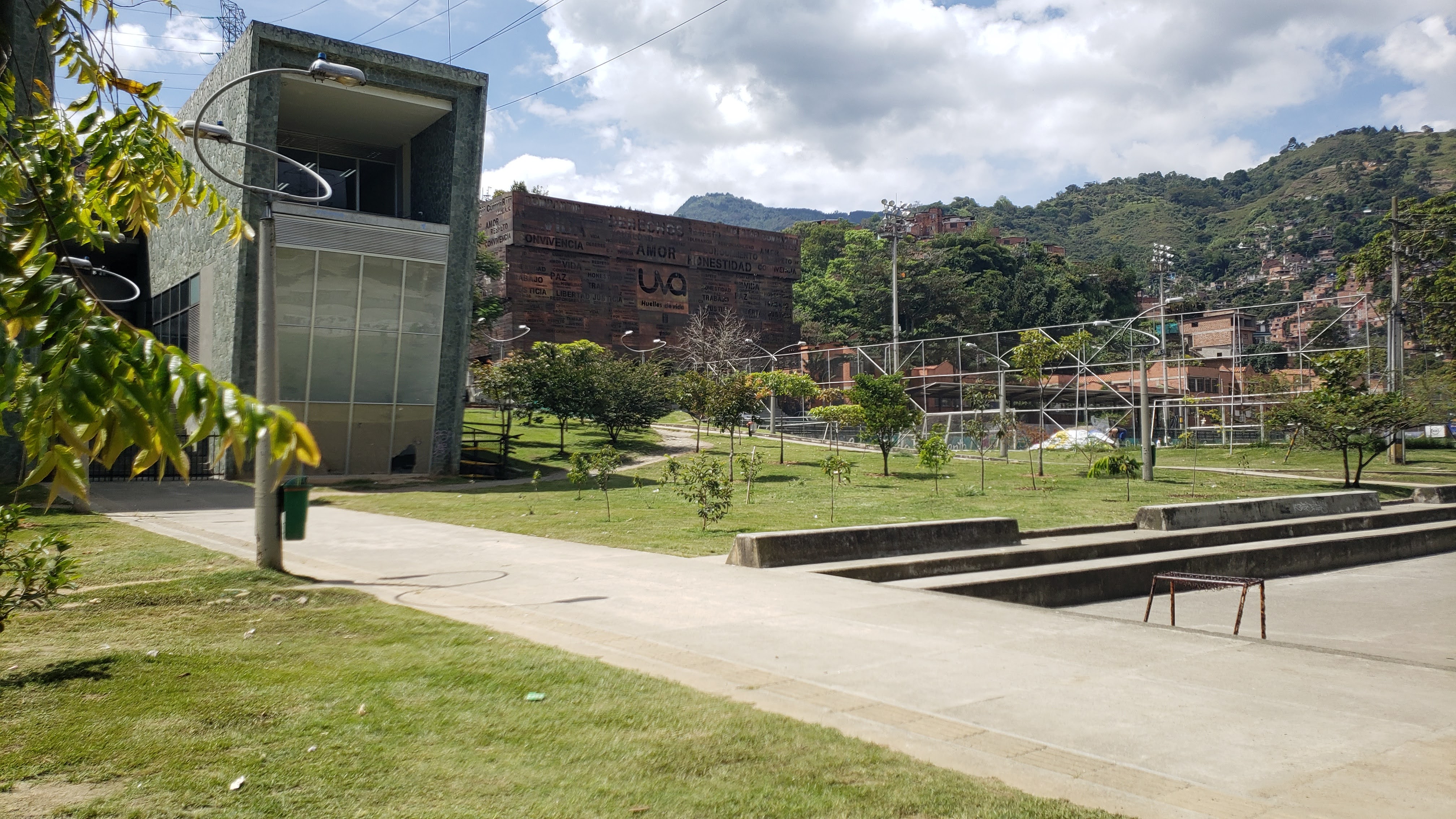 Two modern, high-design buildings with a large grassy lawn in front