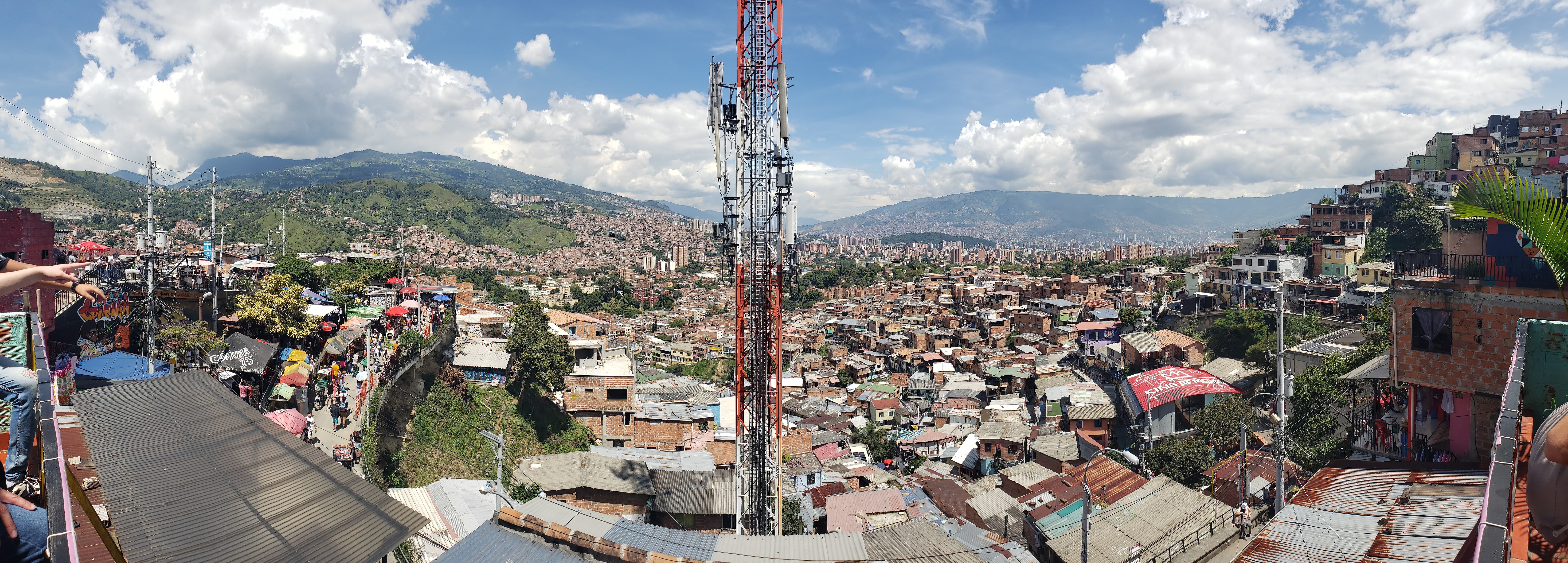 Rooftops descend to the valley floor far below