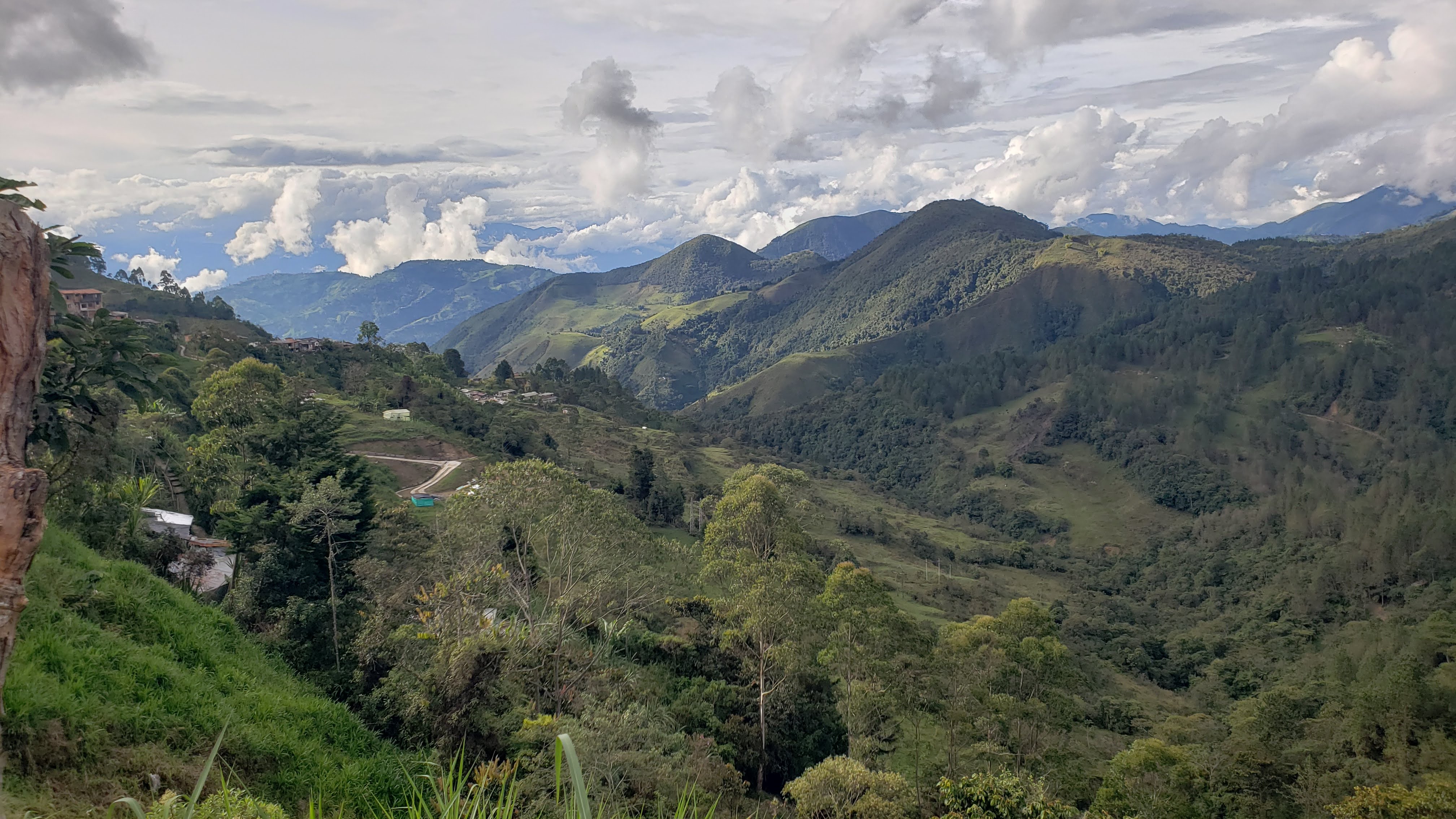 Steep, rolling hills stretching to the horizon under a partly cloudy sky