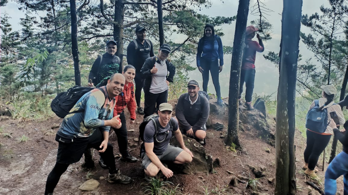 A group of hikers posing in the woods