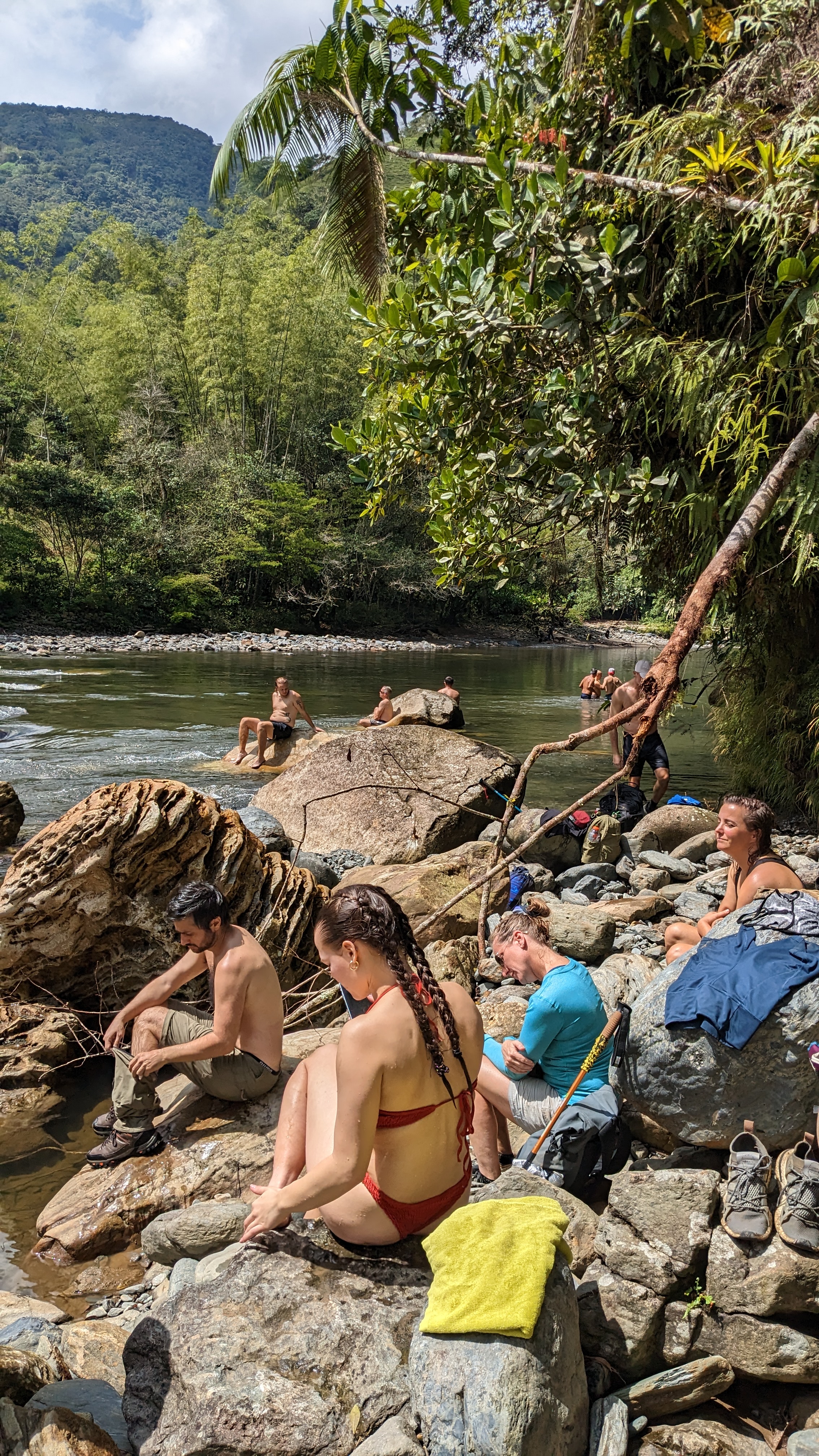 Men and women warming in the sun after a dip in the river